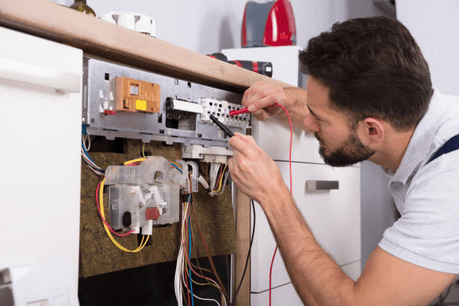 Appliance repair technician inspecting dish washer